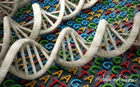 Doble hélice de ADN sobre letras genéticas de colores. El autismo es genético, un mensaje de esperanza y comprensión. #JuntosEnElAutismo